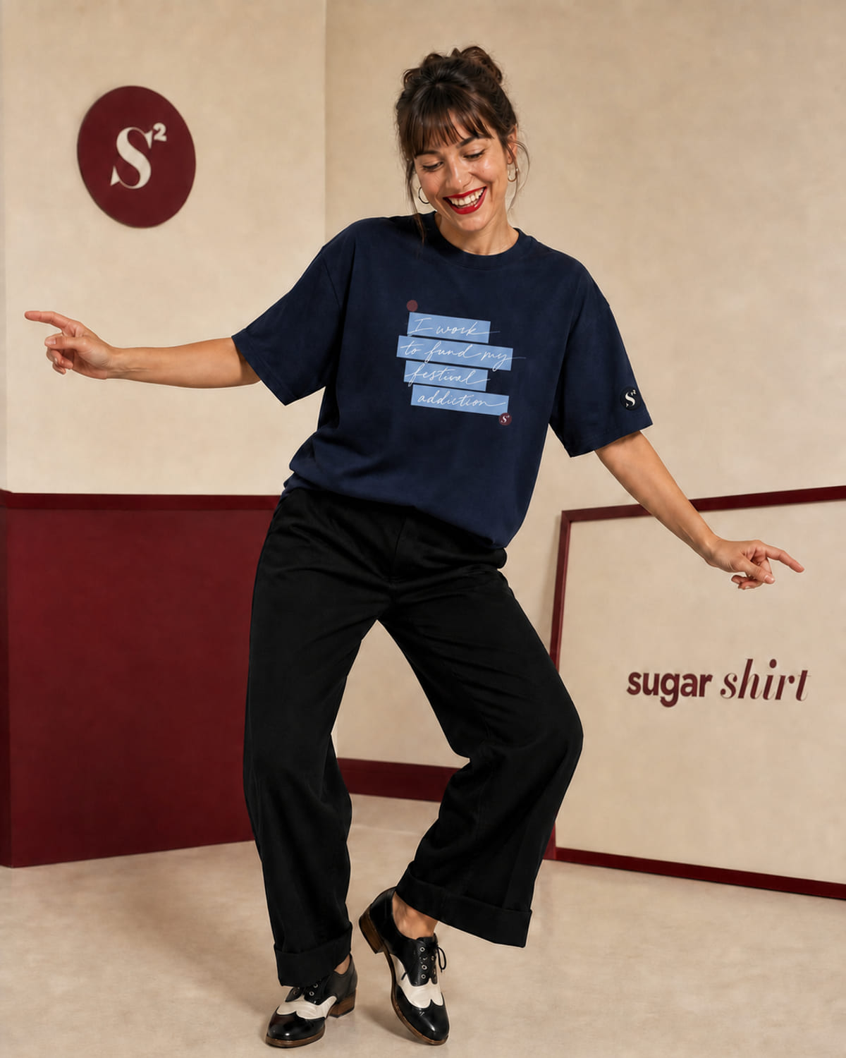 T-shirt oversize navy con la frase «I work to fund my festival addiction» scritta a mano su evidenziatore azzurro